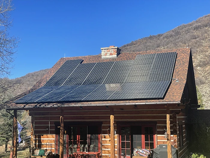 Installer securing solar panels on a rooftop